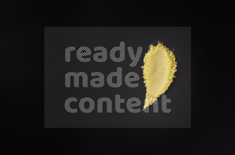 Yellow powder strokes on black background