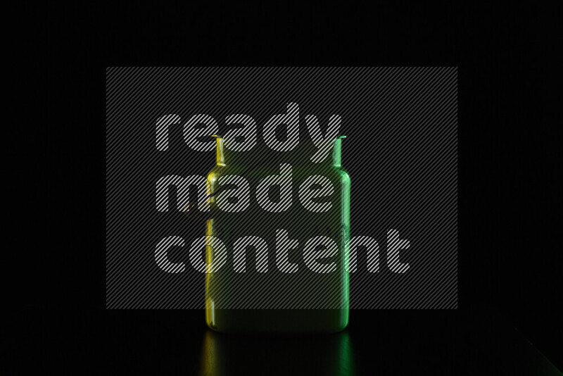 A vintage milk canister with colored rim light against black background