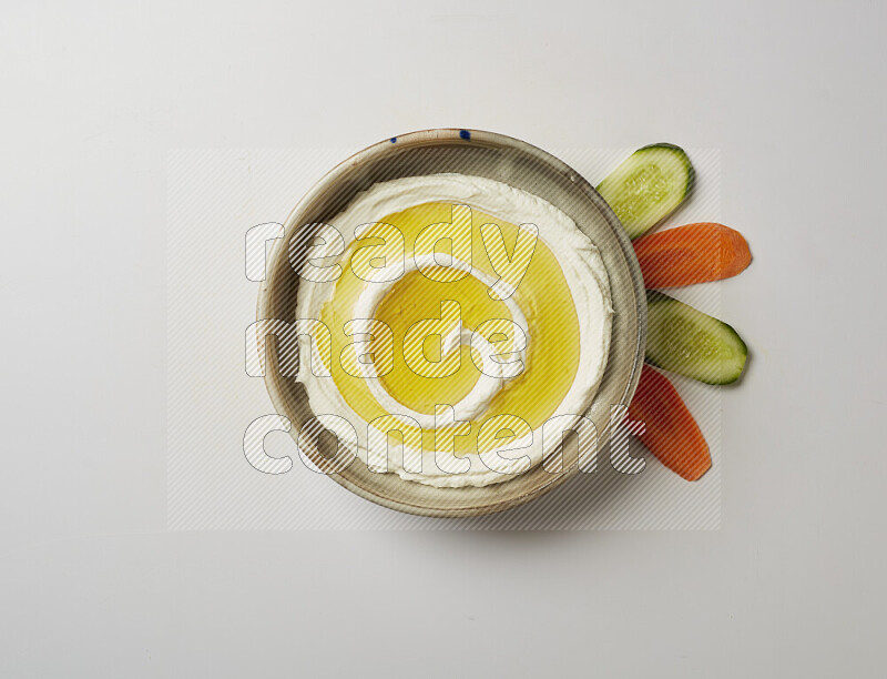 Lebnah garnished with olive oil in a grey pottery plate on a white background