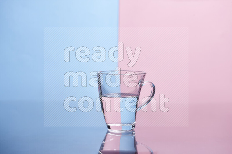 The image features a clear glassware filled with water, set against light blue and rose background