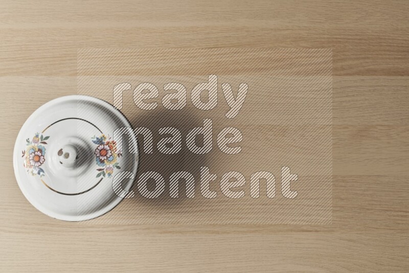 A vintage metal pot on light wooden background