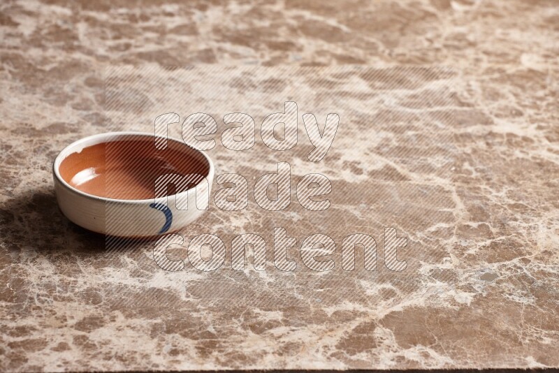 Multicolored Pottery Bowl on Beige Marble Flooring