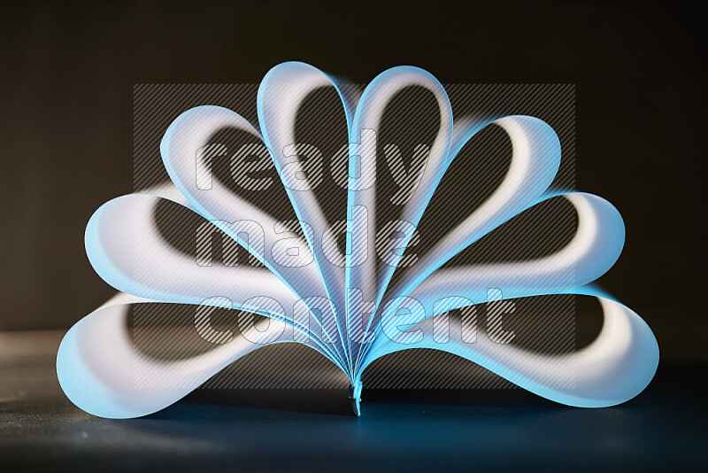 An abstract art piece displaying smooth curves in blue and white gradients created by colored light