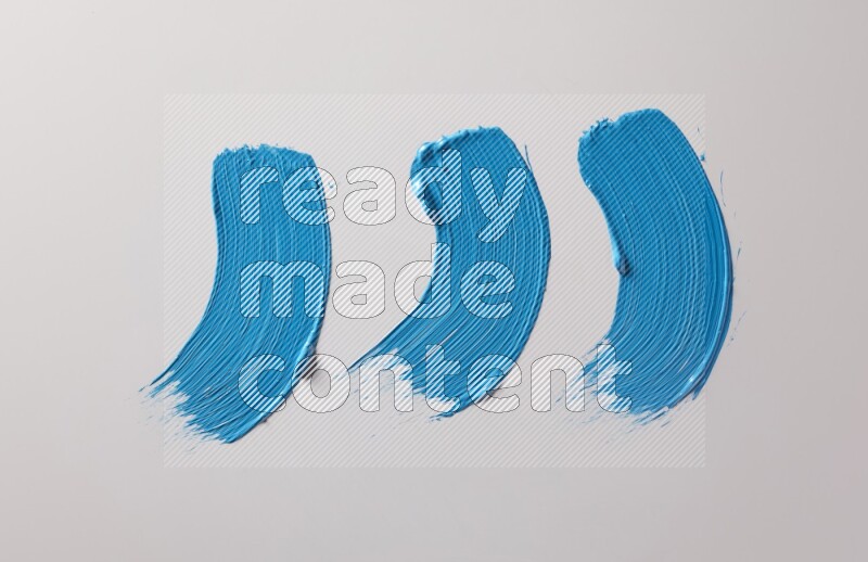 Multi blue curved brush strokes shaped into different shapes on a white background