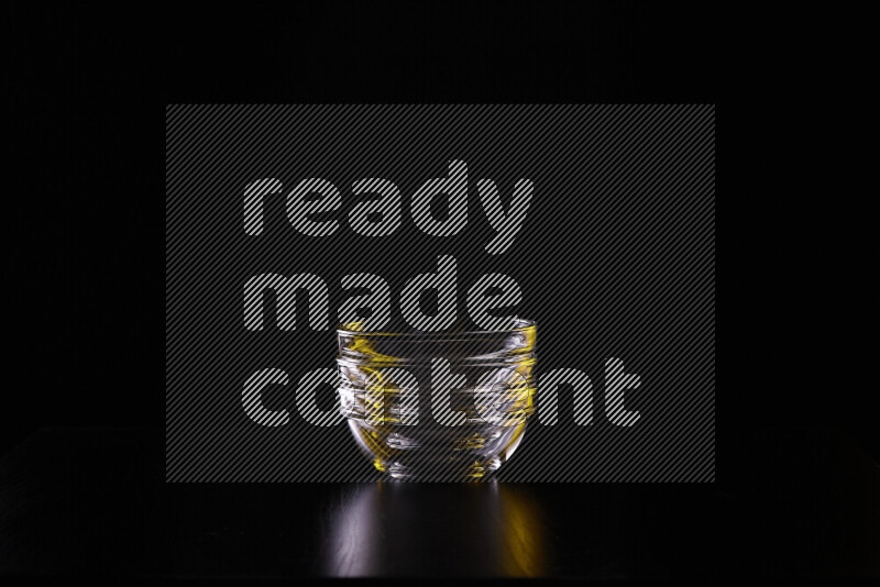 Glassware with rim light in yellow and white against black background