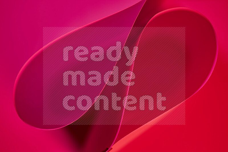 An abstract art of paper folded into smooth curves in red gradients