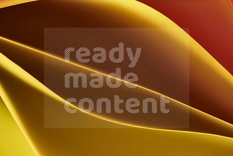 This image showcases an abstract paper art composition with paper curves in yellow, red and brown gradients created by colored light