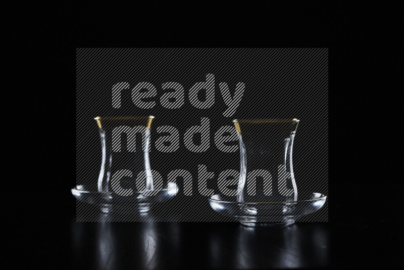 Glassware with rim light against black background