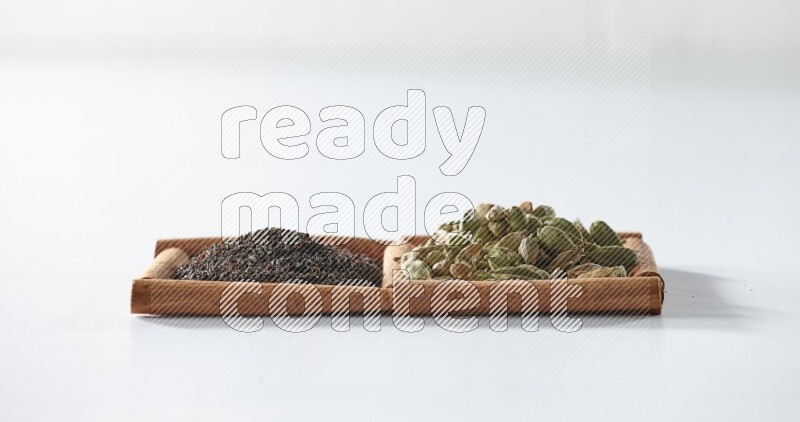 2 squares of cinnamon sticks full of black tea and cardamom on white flooring