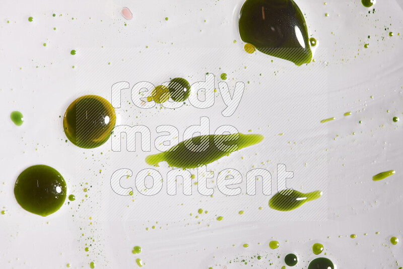 Close-ups of abstract green paint droplets on the surface