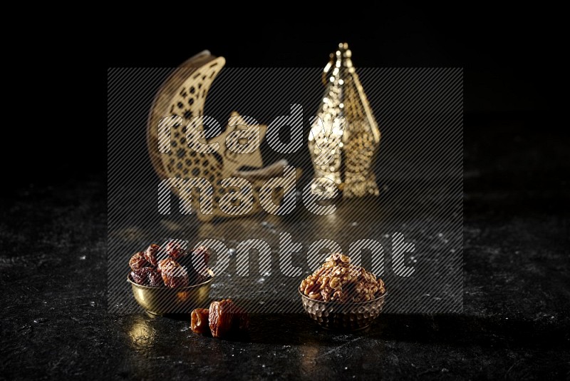Dates in a metal bowl with walnuts beside golden lanterns in a dark setup