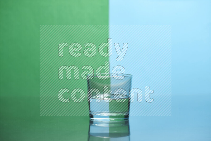 The image features a clear glassware filled with water, set against green and light blue background