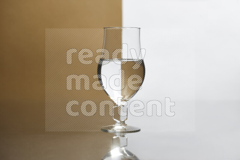 The image features a clear glassware filled with water, set against white and beige background