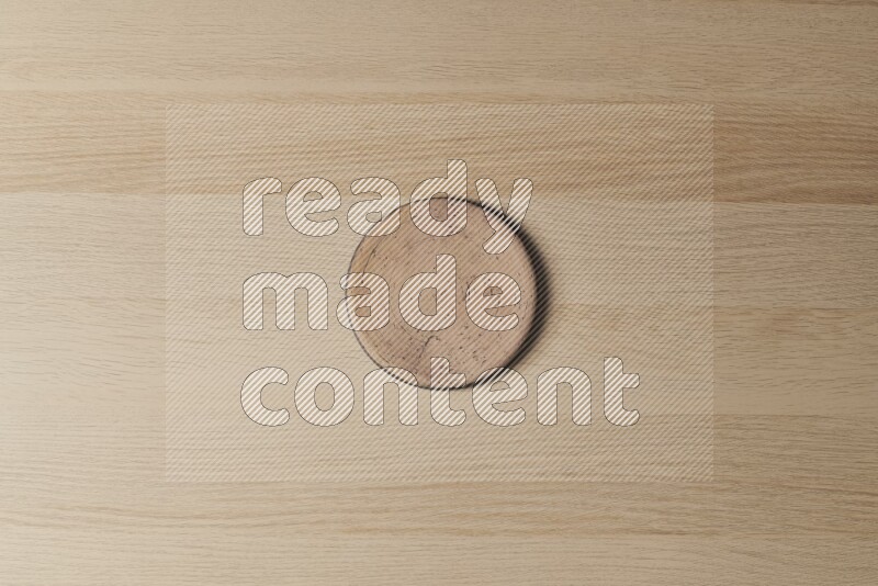 A pottery coaster on light wooden background