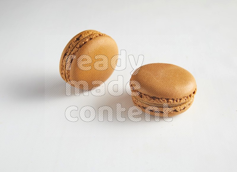 45º Shot of two Brown Maple Taffy macarons on white background
