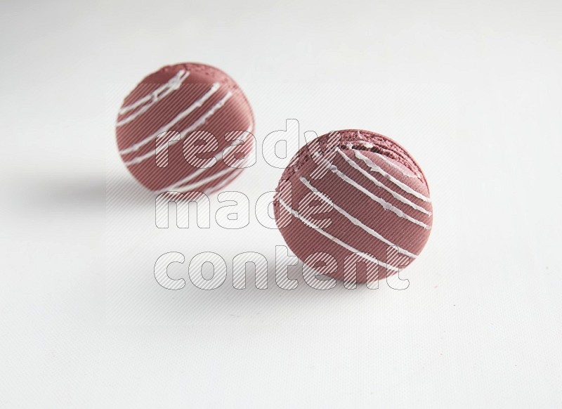 45º Shot of two Red Poppy Flower macarons on white background