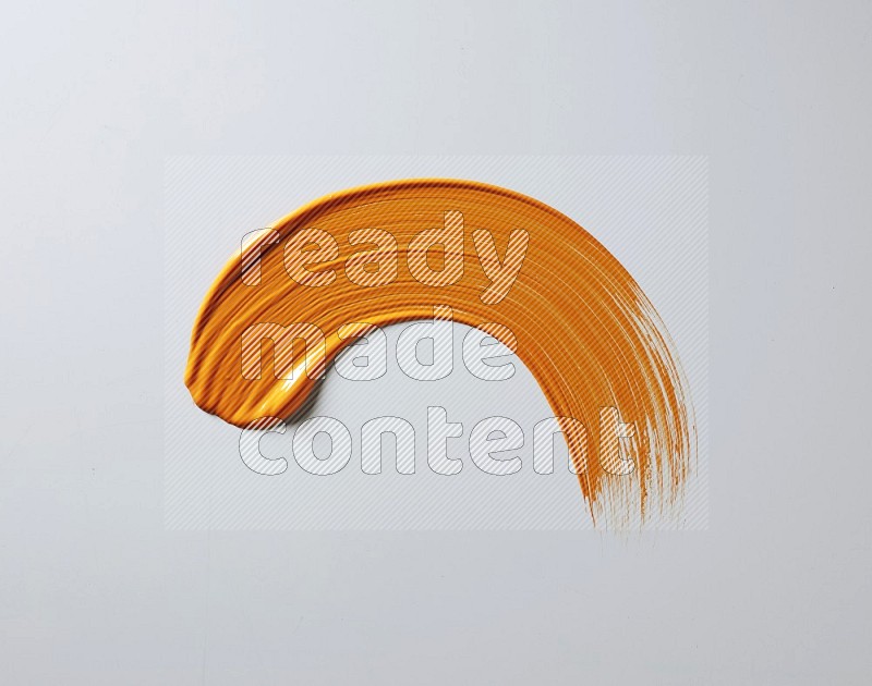 An orange half circular painting brush stroke on white background