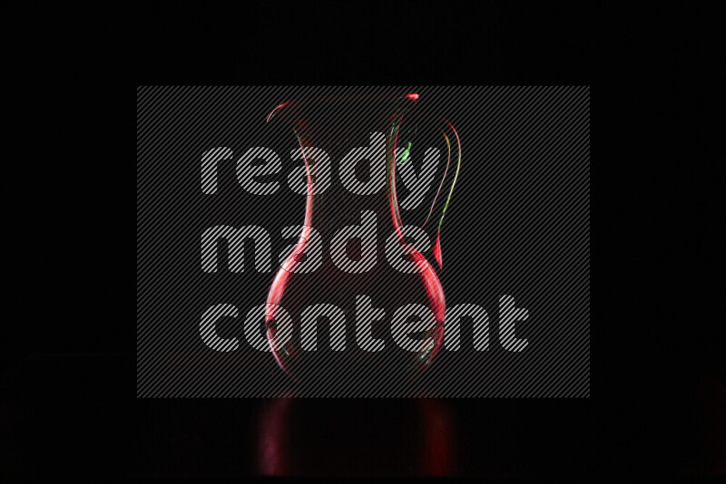 Glassware with rim light in red against black background