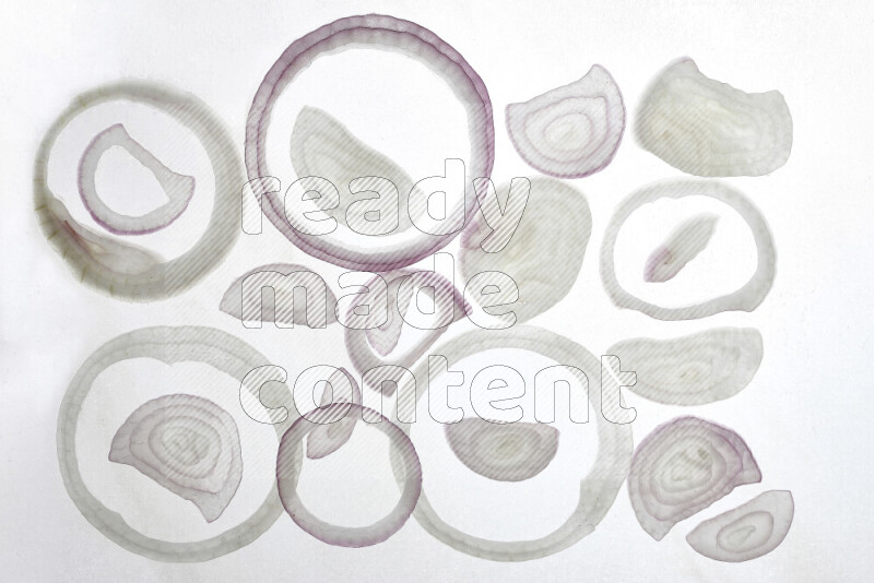 Onion slices on illuminated white background