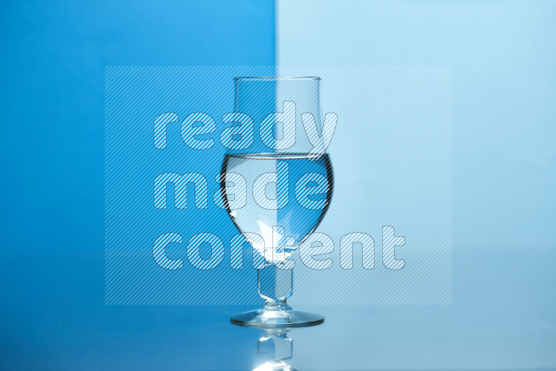 The image features a clear glassware filled with water, set against blue and light blue background