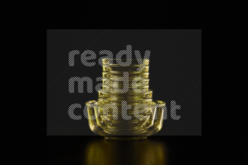 Glassware with rim light in yellow against black background