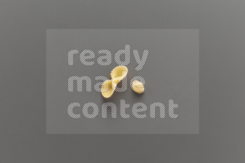 Fiocchi pasta with other types of pasta on grey background