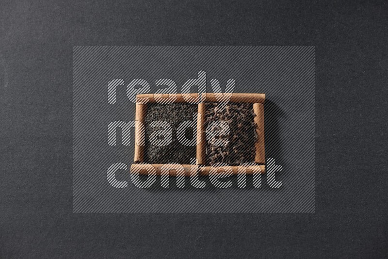 2 squares of cinnamon sticks full of tea and cloves on black flooring