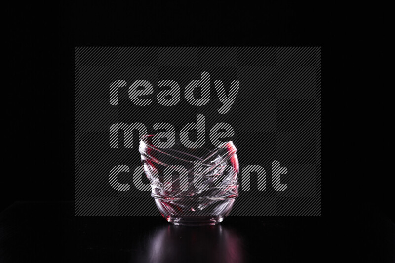 Glassware with rim light in red and white against black background