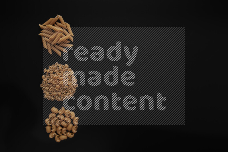 Different pasta types in 3 bunches on black background