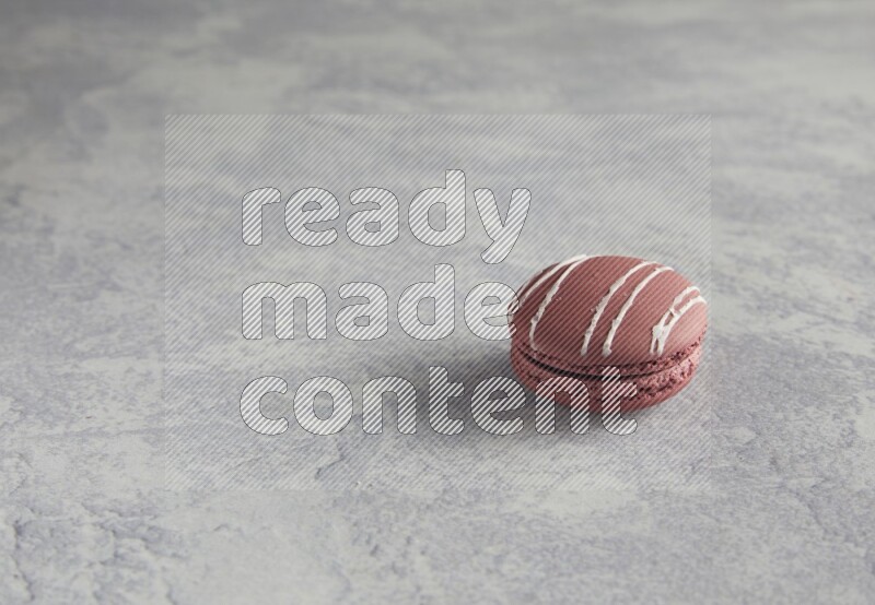 45º Shot of Red Poppy Flower macaron on white  marble background