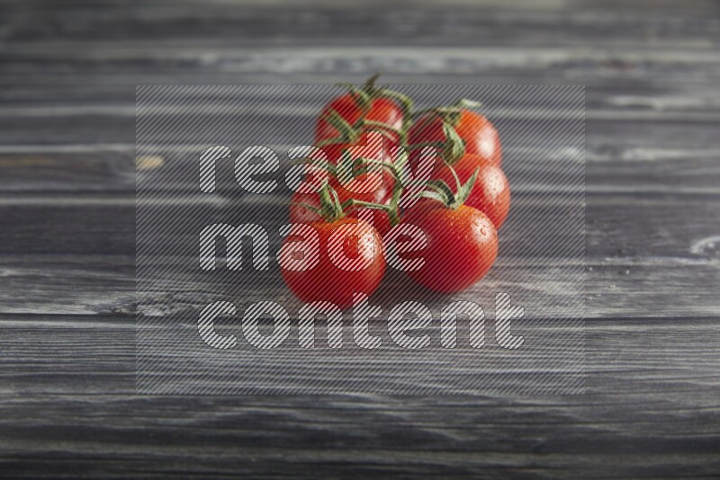 Red cherry tomato vein on a textured grey wooden background 45 degree