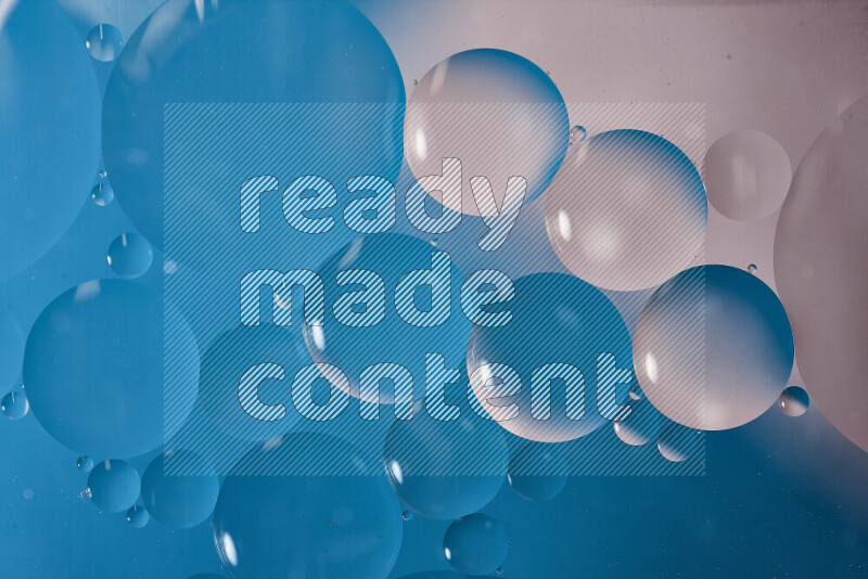 لقطات مقربة لفقاعات من الزيت على سطح الماء باللون الأبيض والأزرق