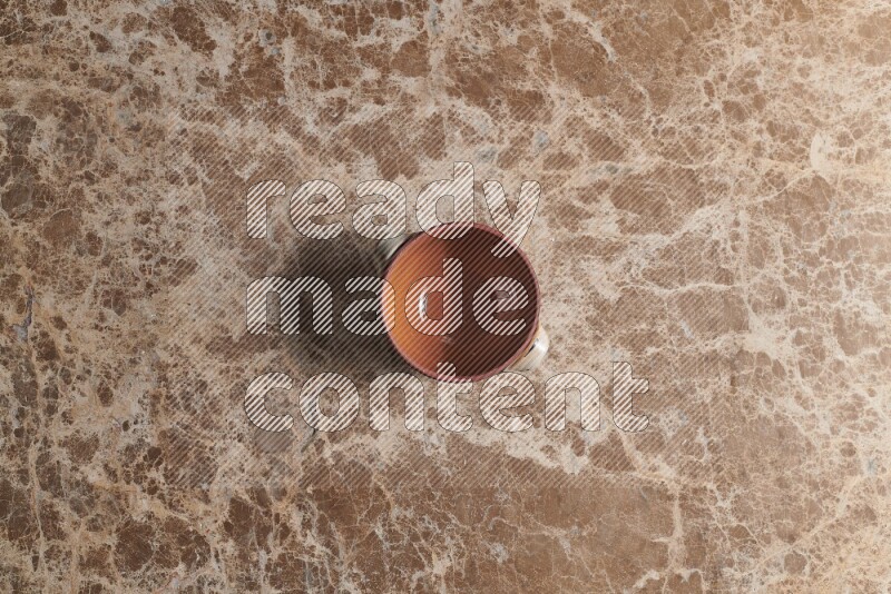 A multicolored pottery pot on beige marble background