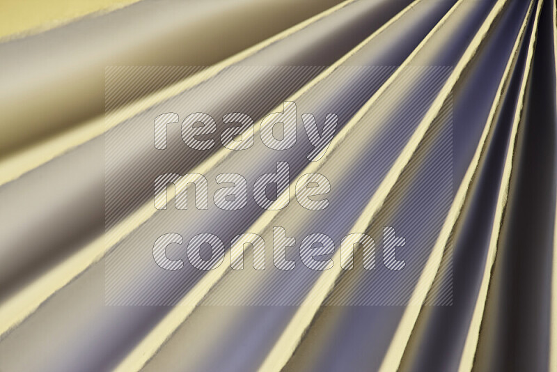 An image presenting an abstract paper pattern of lines in white and gold tones