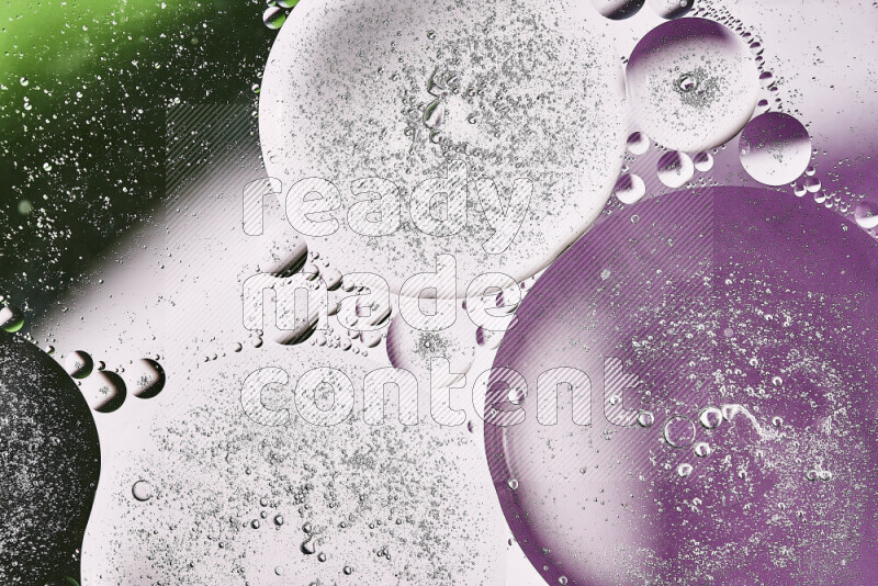 Close-ups of abstract oil bubbles on water surface in shades of purple, green and white