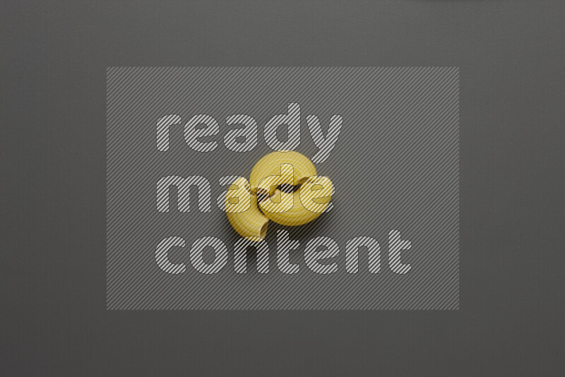Elbow pasta on grey background
