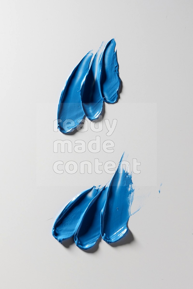 Blue painting knife strokes on white background