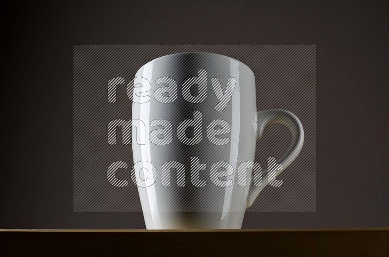 Low angle shot of a white cup on grey background