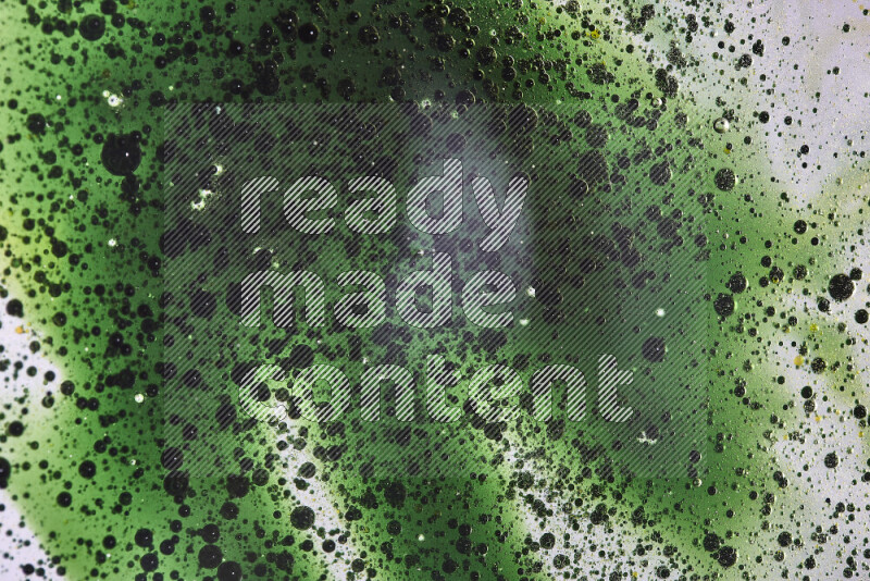 Close-ups of abstract green watercolor drops on oil Surface on white background