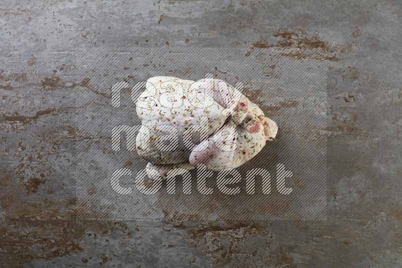 whole raw chicken  direct on a rustic grey background