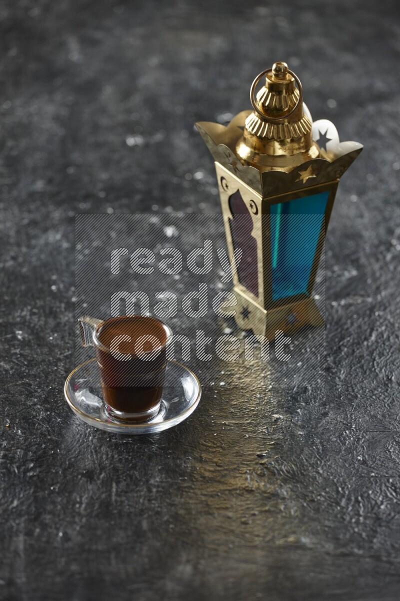 A golden lantern with different drinks, dates, nuts, prayer beads and quran on textured black background