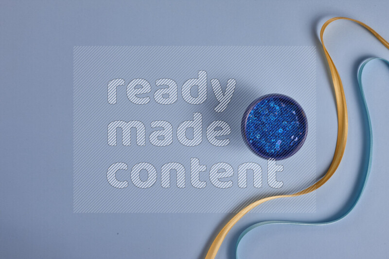 A yellow and blue collection of sewing and tailoring tools arranged on a blue background
