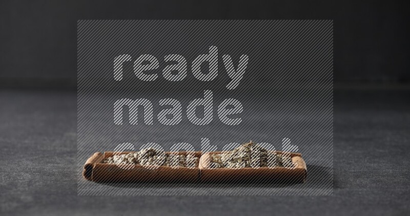 2 squares of cinnamon sticks full of white peppers and cumin on black flooring