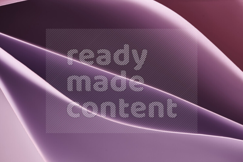 This image showcases an abstract paper art composition with paper curves in purple and pink gradients created by colored light