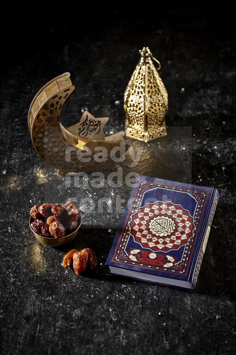 Dates in a metal bowl with quran beside golden lanterns in a dark setup