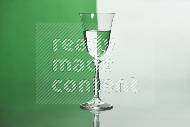 The image features a clear glassware filled with water, set against white and green background