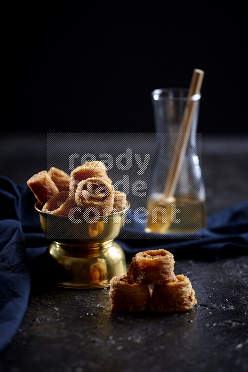 konafa in a metal bowl in a dark setup