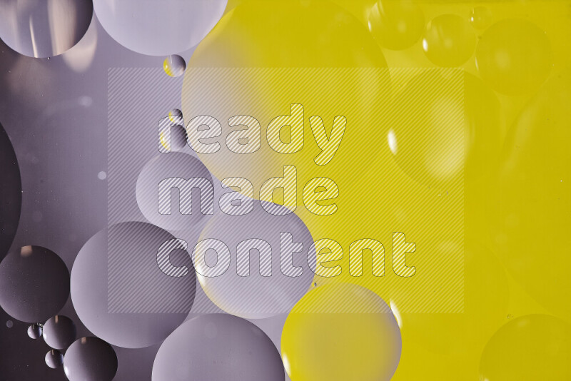 لقطات مقربة لفقاعات من الزيت على سطح الماء باللون الأسود والأصفر