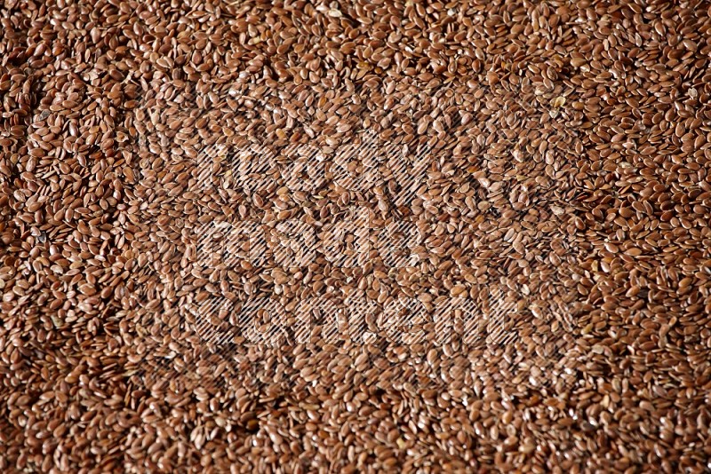 Flaxseeds Filling the Frame on a black Flooring