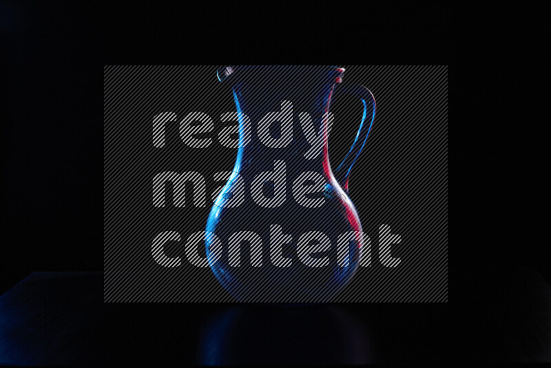 Glassware with rim light in red and blue against black background